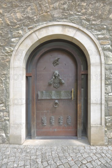 Door with fittings and entrance to the cathedral, front door with decorations and door knocker