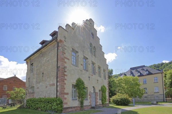 Gothic house with stepped gable in the backlight of the former Cistercian abbey and today's