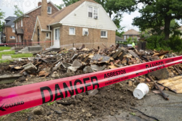 Detroit, Michigan - Signs warn of asbestos danger where a house was demolished. The house had been