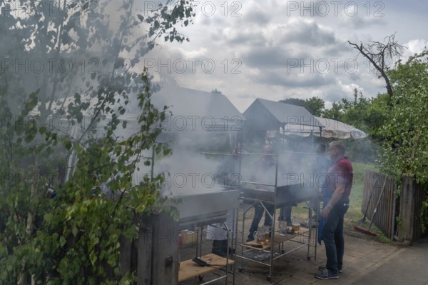 Heavy smoke at the sausage grill stations at the Backofenfest, Kleingeschaidt, Middle Franconia,