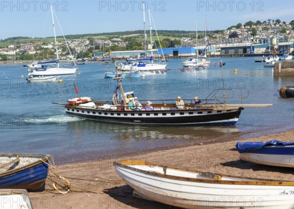 Shaldon ferry arriving, small boats in harbour at Back Beach, Teignmouth, south Devon, England, UK