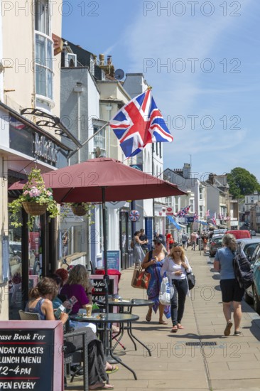 Union Jack flags on shops in street of historic buildings, The Strand, Dawlish, south Devon,