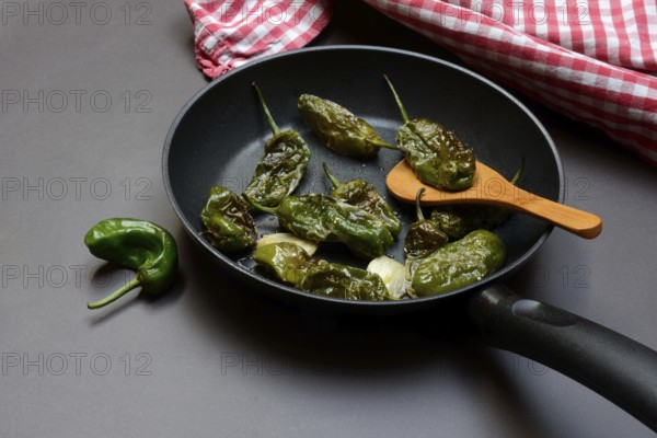 Pan-fried pimientos de padron in olive oil, roast peppers