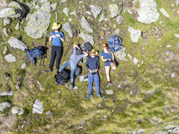 Group of mountaineers taking a break, rest with Ickerchen in the mountains, from above, Valais,