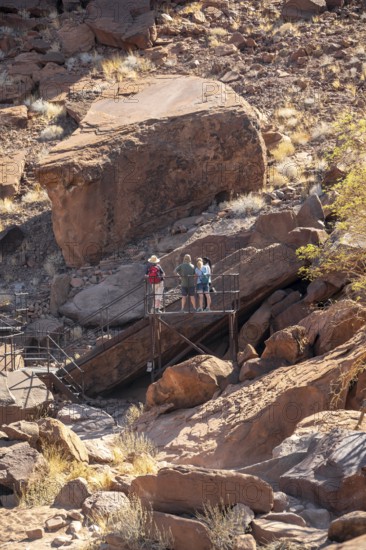 Tourists on a platform at the rock engravings of Twyfelfontein, Twyfelfontein, Kunene, Namibia
