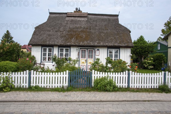 White thatched house with lovingly designed front garden. Wieck, Mecklenburg-Western Pomerania,