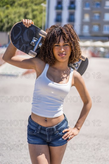 Stylish young woman holding her skateboard on her shoulder, showcasing a blend of confidence and