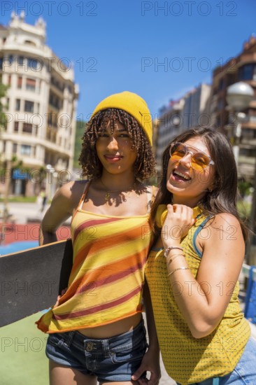 Two female friends enjoying a sunny day in the city, showcasing their youthful energy and urban