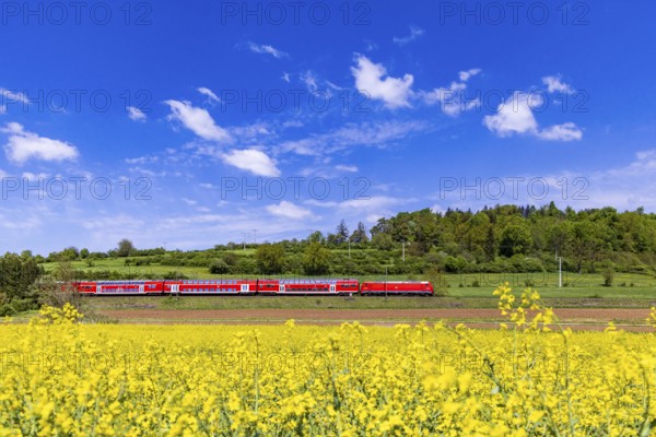RegionalExpress RE5 en route on the Swabian Alb. Landscape along the railway line in spring.