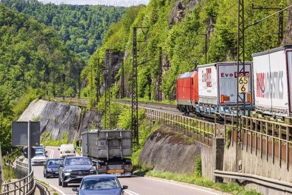 Goods train on the winding railway line of the Geislinger Steige, next to the federal road 10.