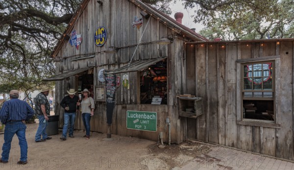 Tourists drinking beer at an open-air bar in Luckenbach, Texas, USA