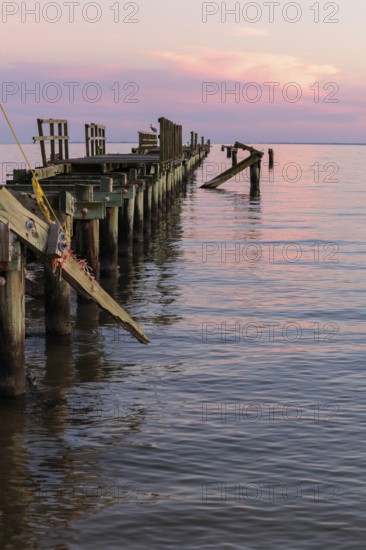 Dilapidated fishing pier damaged from hurricanes in Long Beach, Mississippi, USA