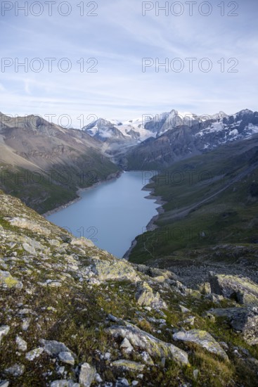View at the summit of Mont de la Blana, view of a blue mountain lake, Lac des Dix reservoir, behind