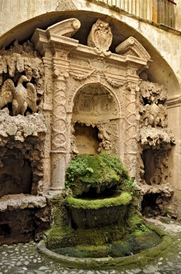 Ornamental fountain from the Renaissance, fountain with moss and artificial dripstone from the