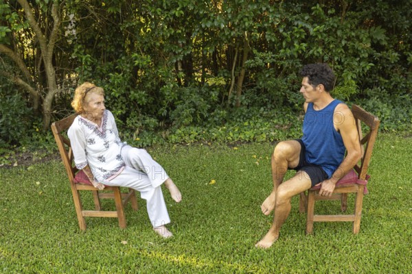 Physiotherapist guides a senior woman through gentle rehabilitation exercises, focusing on mobility