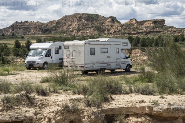 Camper van, colorful sandstone rock formations, desert, gravel road Ruta Jubierre, Desierto de los