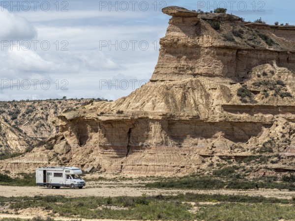 Camper van, desert, rock formation Tozal Colasico, colorful sandstone, gravel road Ruta Jubierre,