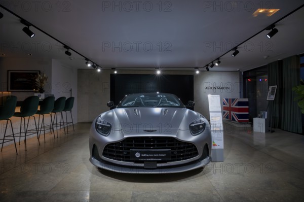 View through shop window to showroom, interior shot, sales exhibition of the car brand Aston