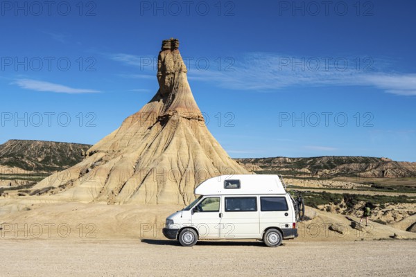 Camper van in front of Castildetierra rock formation, semi-desert, Bardena Blanca area, Bardenas