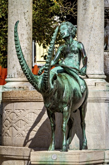 Bronze figure of a rider on a mystical animal, skilfully designed with long horns, The fountain in