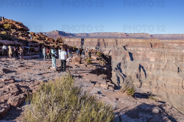 Tourists on the edge of the canyon at Guano Point area of Grand Canyon West near Peach Springs,