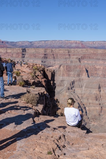 Tourists on the edge of the canyon at Guano Point area of Grand Canyon West near Peach Springs,