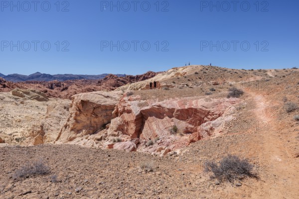 Hikers on the trail to an overlook at the end of Fire Canyon Road at Valley of Fire State Park near
