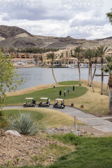 Senior golfers teeing off while playing on a golf course along the shoreline of Las Vegas Wash at