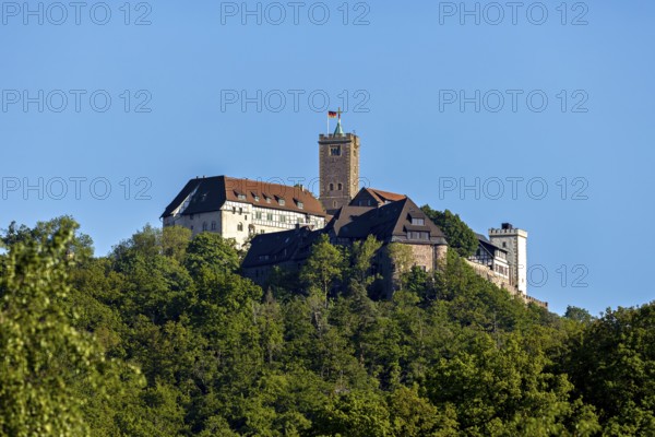 Castle on a green hill under a bright sky, Wartburg Castle near Eisenach in Thuringia