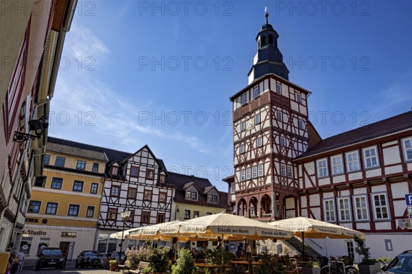 Market square with half-timbered houses and tower under a bright blue sky, The town hall of