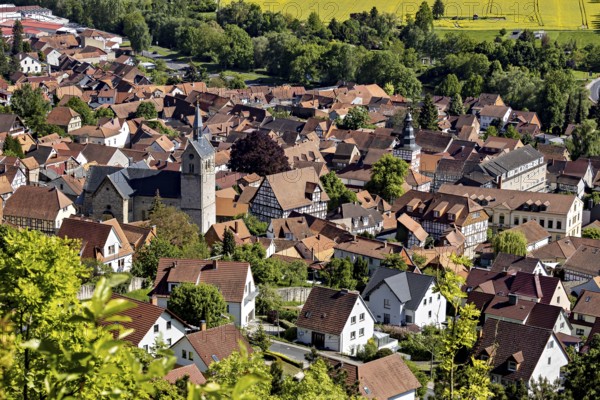 Panorama of a small town with a church, surrounded by fields and green countryside, The town of