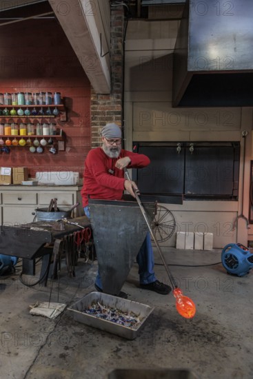 Glass blower demonstrates the art of blowing glass at the Dollywood amusement park in Pigeon Forge,