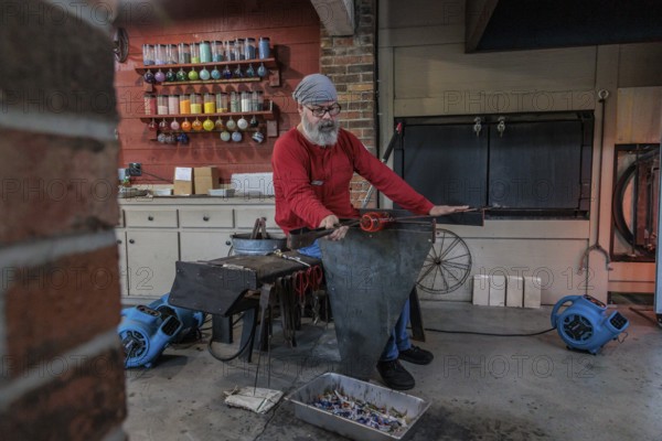 Glass blower demonstrates the art of blowing glass at the Dollywood amusement park in Pigeon Forge,