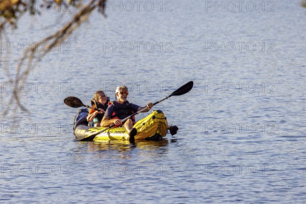 Senior couple paddleing a an inflatable kayak on Archusa Creek Lake at Archusa Creek Water Park