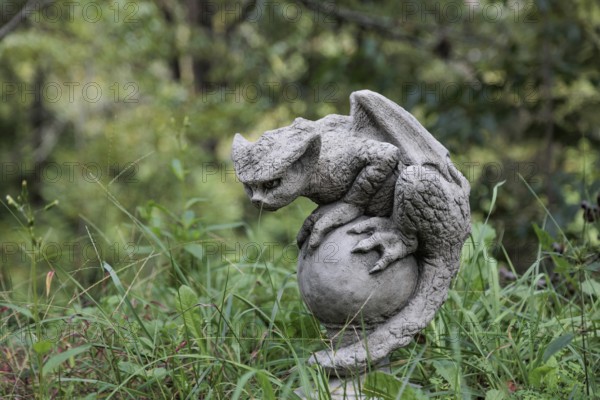 Sculpture of a gargoyle like mythical creature near the entrance to Dismals Canyon near Phil