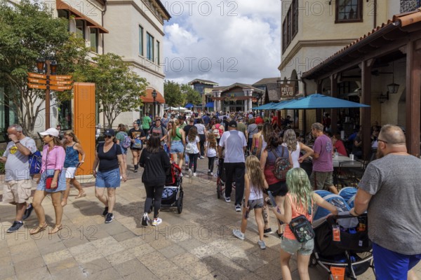 Crowd of visitors walking past The Polite Pig restaurant in Disney Springs at Disney World in