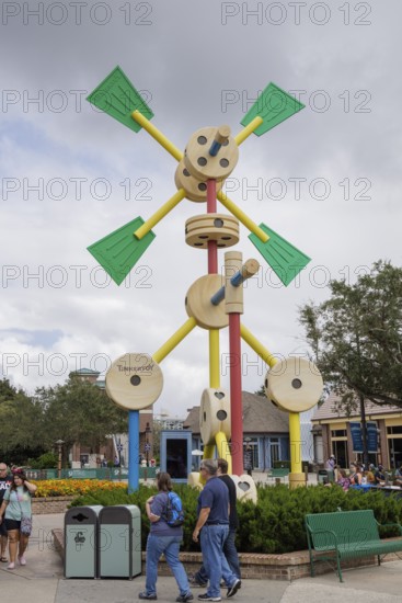 Shoppers and visitors walking past a Tinkertoy sculpture display in Disney Springs at Disney World