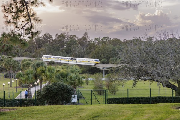 Monorail carries passengers toward the entrance to the Magic Kingdom at Walt Disney World in