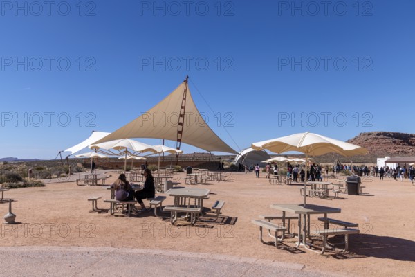 Umbrella shaded tables and a large awning provide visitors shade from the desert sun at Eagle Point