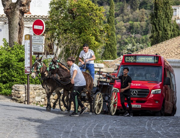 Horse-drawn carriage in the narrow streets of Granada, modern bus behind, Granada, Andalusia, Spain