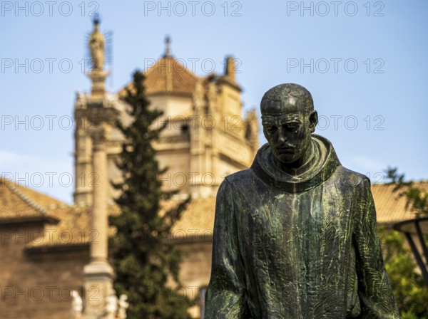 Statue of Johannes von Gott, Granada, royal hospital in the back, Granada, Andalusia, Spain