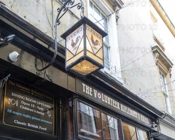 Vintage Courage pub lamp sign outside The Volunteer Rifleman's Arms pub, city of Bath, north east