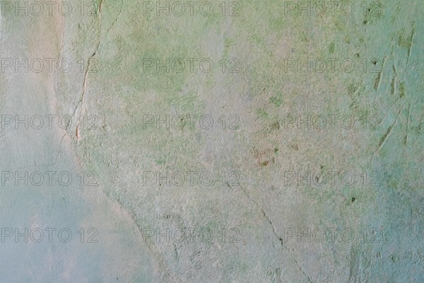 Greenish, cracked wall with rough texture and abstract appearance, background, texture,