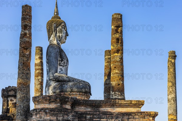 Stone Buddha statue in the historic Wat Mahathat Buddhist temple complex, historical park,