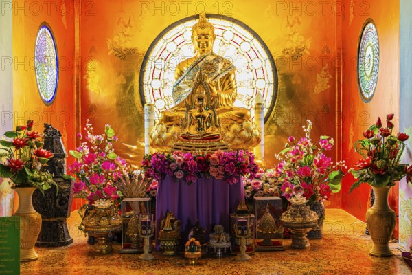Shrine with gilded Buddhist statue in the main pagoda, Buddhist temple complex Wat Phra That Sorn