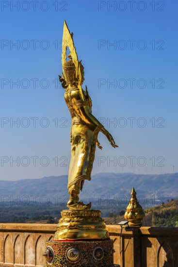 Standing gilded Buddha statue on a viewing terrace, Wat Phra That Sorn Kaew Buddhist temple