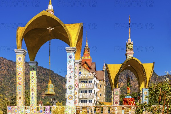 Round arch bell tower decorated with colorful mosaics and glass works of art, Buddhist temple