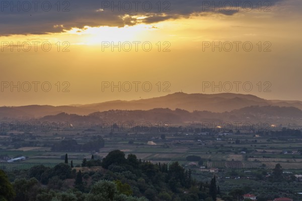 Fields and hills in the distance under a glowing sky at sunset, Hotel Europa, garden restaurant and