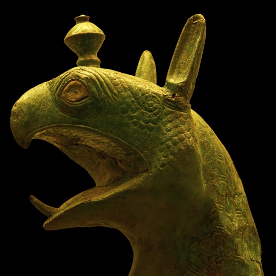 Bronze griffin protome, mystical animal head sculpture made of green material with detailed design,