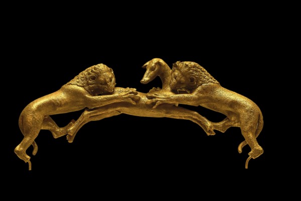 Two golden lions attacking a deer on a dark background, handle of a bronze vessel, Olympia